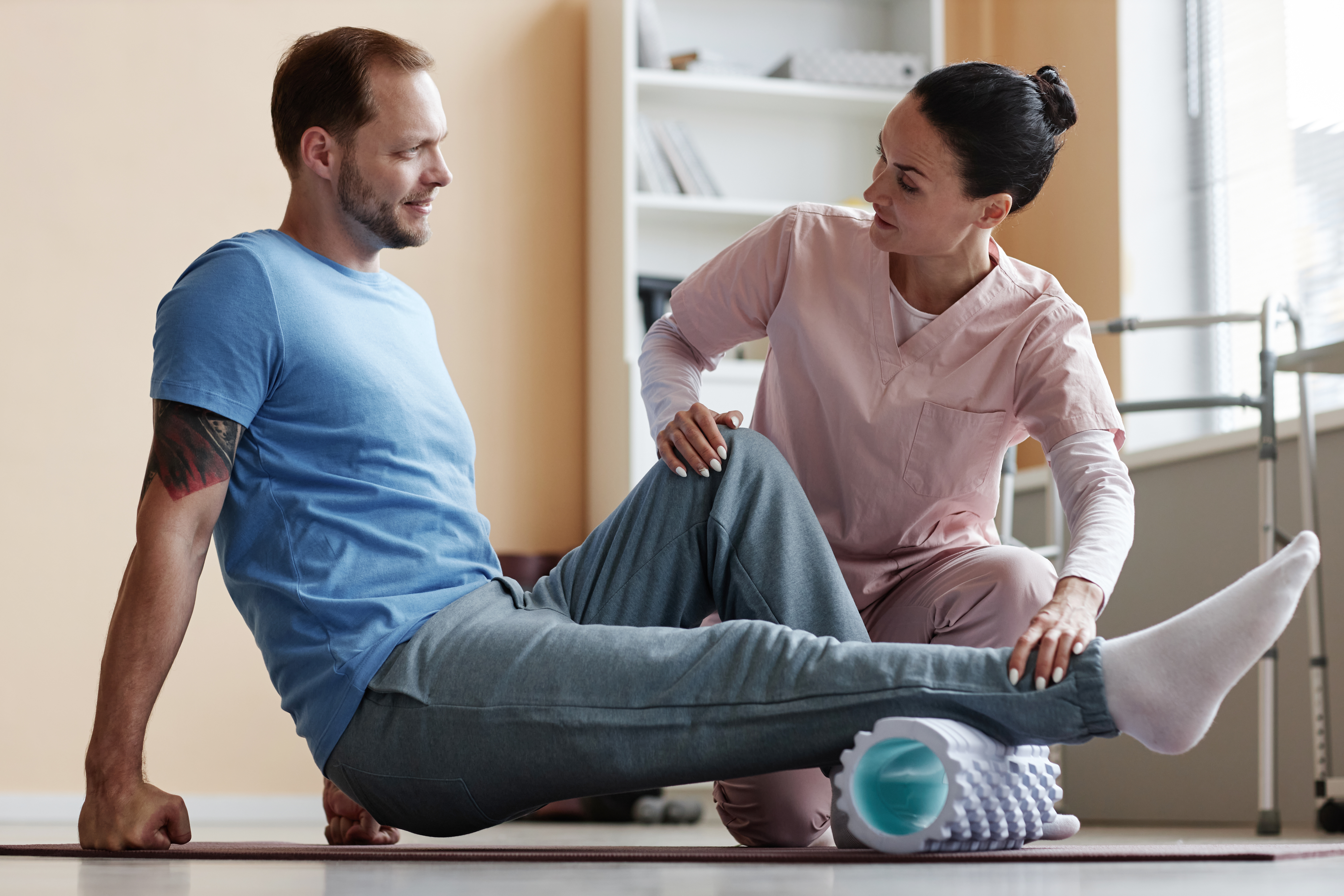 patient-exercising-exercise-mat-with-massager-together-with-therapist-rehabilitation